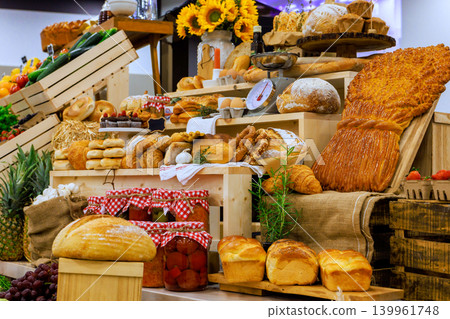 Variety of bread pastries are arranged on wooden crates at local market. Variety of bread pastries are arranged on wooden crates at local market. 139961748