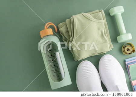 Fitness essentials planning healthy active lifestyle on green background Fitness essentials planning healthy active lifestyle on green background 139961905