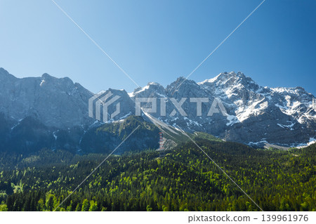 Travel landscape of Zugspitze Alps in Bavaria Germany, scenic summer nature panorama with forest, snow mountains peak Travel landscape of Zugspitze Alps in Bavaria Germany, scenic summer nature panorama with forest, snow mountains peak 139961976