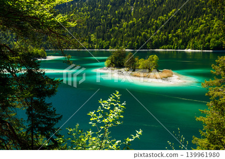 Travel landscape of Eibsee lake and island in Alps in Bavaria Germany, scenic summer nature panorama with forest Travel landscape of Eibsee lake and island in Alps in Bavaria Germany, scenic summer nature panorama with forest 139961980