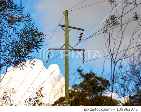 Wooden telephone poles against a vibrant blue sky in the Blue Mountains Wooden telephone poles against a vibrant blue sky in the Blue Mountains 139962078