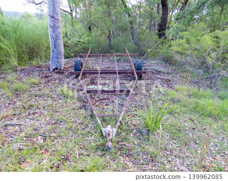 An old and rusty trailer abandoned in a forest 139962085