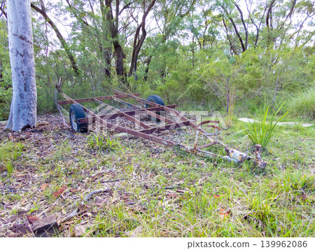 An old and rusty trailer abandoned in a forest 139962086