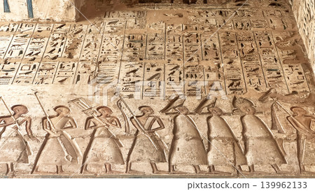 Beautiful bas-reliefs and ancient hieroglyphs from the mortuary temple of Ramesses III at Medinet Habu, Luxor, Egypt. 139962133