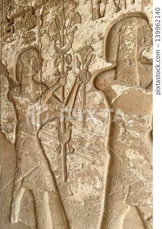 Beautiful bas-reliefs and ancient hieroglyphs from the mortuary temple of Ramesses III at Medinet Habu, Luxor, Egypt. Beautiful bas-reliefs and ancient hieroglyphs from the mortuary temple of Ramesses III at Medinet Habu, Luxor, Egypt. 139962140