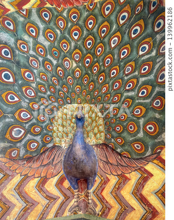 A colorful ceiling painting featuring peacocks, ornaments, and slanted motifs in a palace in Jaipur, India. A colorful ceiling painting featuring peacocks, ornaments, and slanted motifs in a palace in Jaipur, India. 139962186