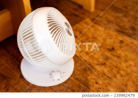 A white air circulator that circulates the air. A white air circulator that circulates the air. 139962479