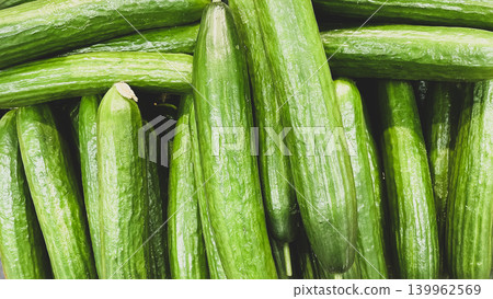 Full frame background of fresh green cucumbers on display at a supermarket grocery counter Full frame background of fresh green cucumbers on display at a supermarket grocery counter 139962569
