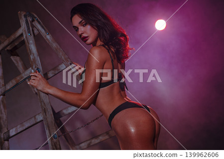 Young sexy woman in black lingerie with stepladder Young sexy woman in black lingerie with stepladder 139962606