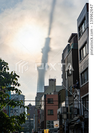 The Tokyo Skytree appears bent and distorted, shrouded in fog. The Tokyo Skytree appears bent and distorted, shrouded in fog. 139962647
