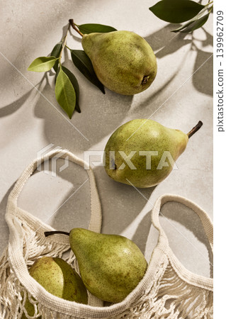 Fresh Italian pears in an Eco-Friendly Mesh Bag on a kitchen table. Top View 139962709