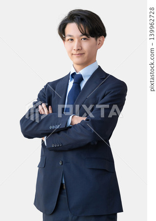 A businessman with his arms crossed. 139962728