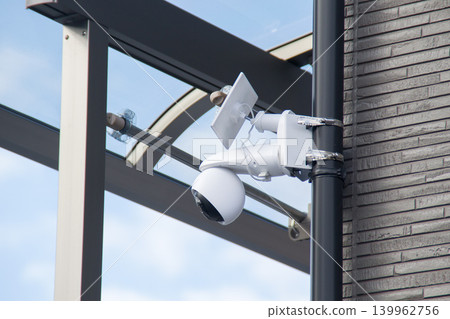 Wireless security camera with solar panel installed on the balcony of a detached house Wireless security camera with solar panel installed on the balcony of a detached house 139962756