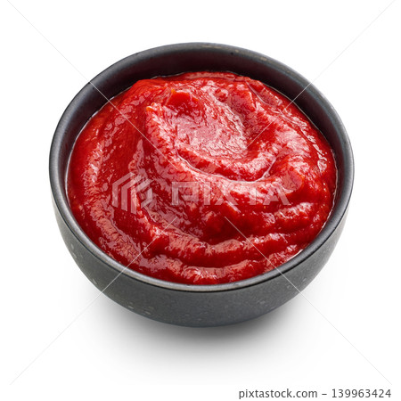 Tomato Sauce or Ketchup in a Black Ceramic Bowl Isolated on White Background Tomato Sauce or Ketchup in a Black Ceramic Bowl Isolated on White Background 139963424