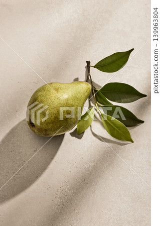 Single Fresh Italian Pear with Green Leaves on a Kitchen Table. Top View Single Fresh Italian Pear with Green Leaves on a Kitchen Table. Top View 139963804