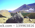 A view of the cairn on Mt. Shiratori in Ebino Plateau, Miyazaki Prefecture, and Mt. Karakuni in the distance. 139963816