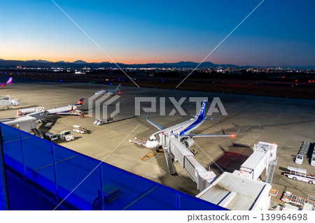 Sendai Airport, twilight time, magic hour, runway bathed in royal blue light, sunset. 139964698
