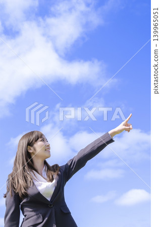 A businesswoman points her finger (with an empty bag). A businesswoman points her finger (with an empty bag). 139965051