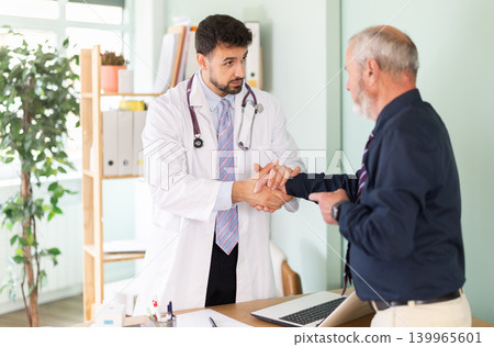 Successful medical appointment, male doctor and mature man patient shake hands. Successful medical appointment, male doctor and mature man patient shake hands. 139965601