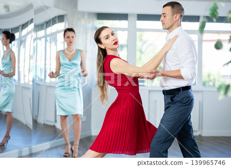 Elegant couple performing expressive tango in dance studio 139965746