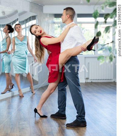 Graceful duet dancing passionate tango during dance class 139965903