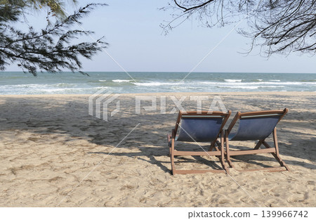 Beach chairs are placed on the sand by the sea. Beach chairs are placed on the sand by the sea. 139966742