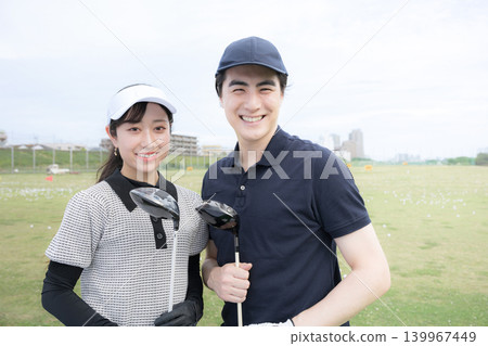 Image of golf lessons or classes: Woman and instructor looking at the camera. Image of golf lessons or classes: Woman and instructor looking at the camera. 139967449