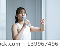 Young woman drinking water 139967496