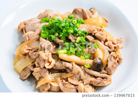 A photo of a Japanese-style stir-fry dish of pork and mushrooms topped with green onions. A photo of a Japanese-style stir-fry dish of pork and mushrooms topped with green onions. 139967815