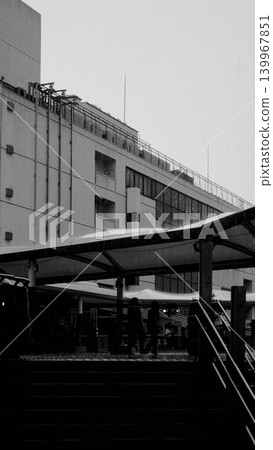 A scene from a pedestrian deck in front of a train station on a rainy day (monochrome), Machida City, Tokyo. 139967851