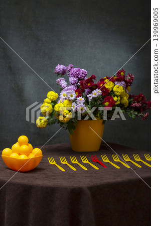 Still life with a bouquet of chrysanthemums in a yellow vase and yellow forks Still life with a bouquet of chrysanthemums in a yellow vase and yellow forks 139969005