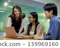 A young business team in their 20s having a meeting in a casual office setting. 139969160