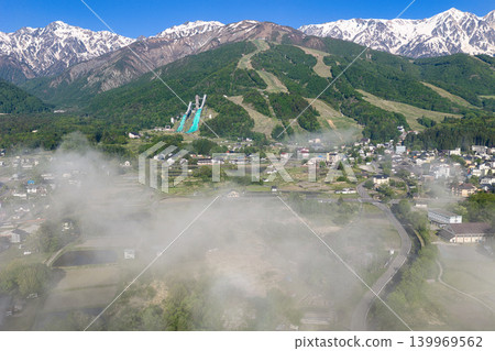 A magnificent sea of clouds and the snow-capped Hakuba mountain range in Hakuba Village, Nagano Prefecture (aerial photography by drone). A magnificent sea of clouds and the snow-capped Hakuba mountain range in Hakuba Village, Nagano Prefecture (aerial photography by drone). 139969562