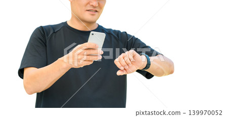 A middle-aged man in sportswear uses a smartwatch for health management and healthcare. A middle-aged man in sportswear uses a smartwatch for health management and healthcare. 139970052