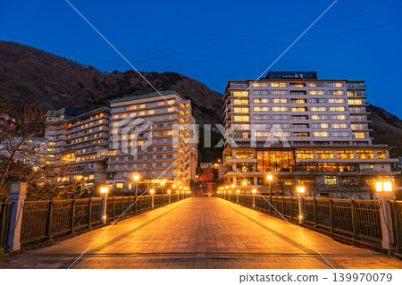 Nikko City, Tochigi Prefecture: A view of the Kinugawa Onsen hotels from Fureai Bridge, illuminated by the blue hour sky and lights. Nikko City, Tochigi Prefecture: A view of the Kinugawa Onsen hotels from Fureai Bridge, illuminated by the blue hour sky and lights. 139970079