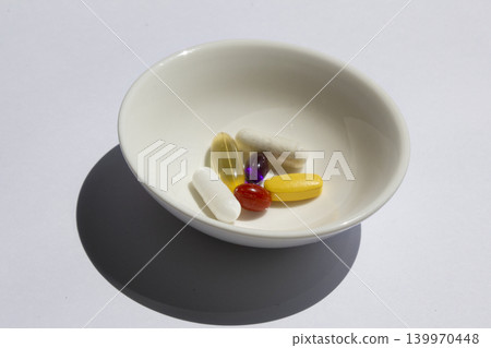 It is pills placed on a small plate. It is pills placed on a small plate. 139970448