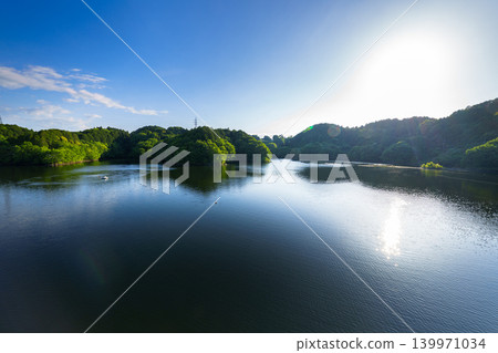 Early summer at Nunome Dam: The blue sky and path of light reflected on the lake's surface, which is filled to the brim (34) Early summer at Nunome Dam: The blue sky and path of light reflected on the lake's surface, which is filled to the brim (34) 139971034
