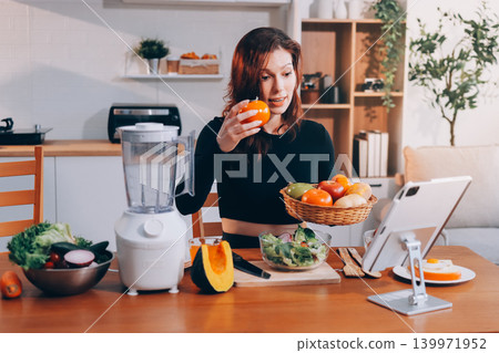 Woman preparing green smoothie in bright kitchen with fresh fruits and vegetables, healthy eating lifestyle moment in natural daylight Woman preparing green smoothie in bright kitchen with fresh fruits and vegetables, healthy eating lifestyle moment in natural daylight 139971952