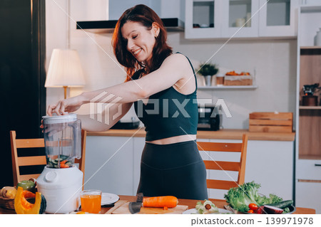 Woman preparing green smoothie in bright kitchen with fresh fruits and vegetables, healthy eating lifestyle moment in natural daylight Woman preparing green smoothie in bright kitchen with fresh fruits and vegetables, healthy eating lifestyle moment in natural daylight 139971978