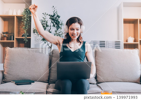 Woman preparing green smoothie in bright kitchen with fresh fruits and vegetables, healthy eating lifestyle moment in natural daylight Woman preparing green smoothie in bright kitchen with fresh fruits and vegetables, healthy eating lifestyle moment in natural daylight 139971993