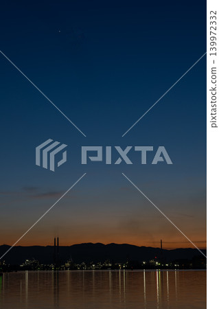 The lights of the Shunan industrial complex reflected in the twilight sky and on the water's surface. The lights of the Shunan industrial complex reflected in the twilight sky and on the water's surface. 139972332