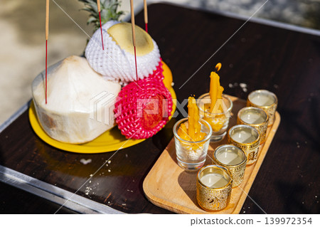 Thai Chinese Worship Offering Set On Table, an outdoor photo capturing traditional offerings arranged on a table, reflecting faith, culture, and ancestral respect. Thai Chinese Worship Offering Set On Table, an outdoor photo capturing traditional offerings arranged on a table, reflecting faith, culture, and ancestral respect. 139972354