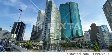 A view of the skyscraper district in the Shinbashi/Shiodome area under a clear blue sky. A view of the skyscraper district in the Shinbashi/Shiodome area under a clear blue sky. 139972404