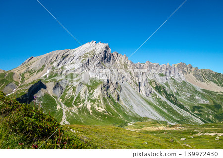 Aiguilles de la Pennaz Limestone cliffs and grassland near Les Contamines Montjoie France Aiguilles de la Pennaz Limestone cliffs and grassland near Les Contamines Montjoie France 139972430