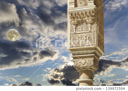 Columns in Islamic (Moorish) style in Alhambra (against the background of a beautiful evening sky with clouds, with the super moon), Granada, Spain Columns in Islamic (Moorish) style in Alhambra (against the background of a beautiful evening sky with clouds, with the super moon), Granada, Spain 139972504