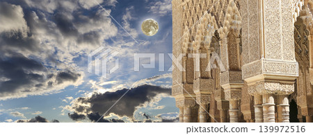 Columns in Islamic (Moorish) style in Alhambra (against the background of a beautiful evening sky with clouds, with the super moon), Granada, Spain Columns in Islamic (Moorish) style in Alhambra (against the background of a beautiful evening sky with clouds, with the super moon), Granada, Spain 139972516