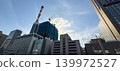 High-rise buildings and cranes under construction in a city undergoing redevelopment. 139972527