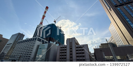 High-rise buildings and cranes under construction in a city undergoing redevelopment. High-rise buildings and cranes under construction in a city undergoing redevelopment. 139972527