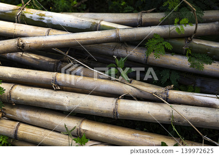 Pile Dry Bamboo Roadside Natural Material Stack, a documentary photo of dried bamboo neatly stacked along a rural road, reflecting local resource use and simple living. Pile Dry Bamboo Roadside Natural Material Stack, a documentary photo of dried bamboo neatly stacked along a rural road, reflecting local resource use and simple living. 139972625