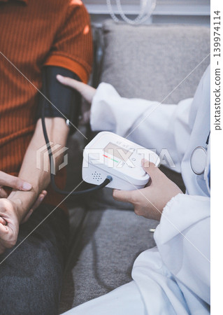 Doctor checks patient's blood pressure with cuff and stethoscope in a medical Doctor checks patient's blood pressure with cuff and stethoscope in a medical 139974114